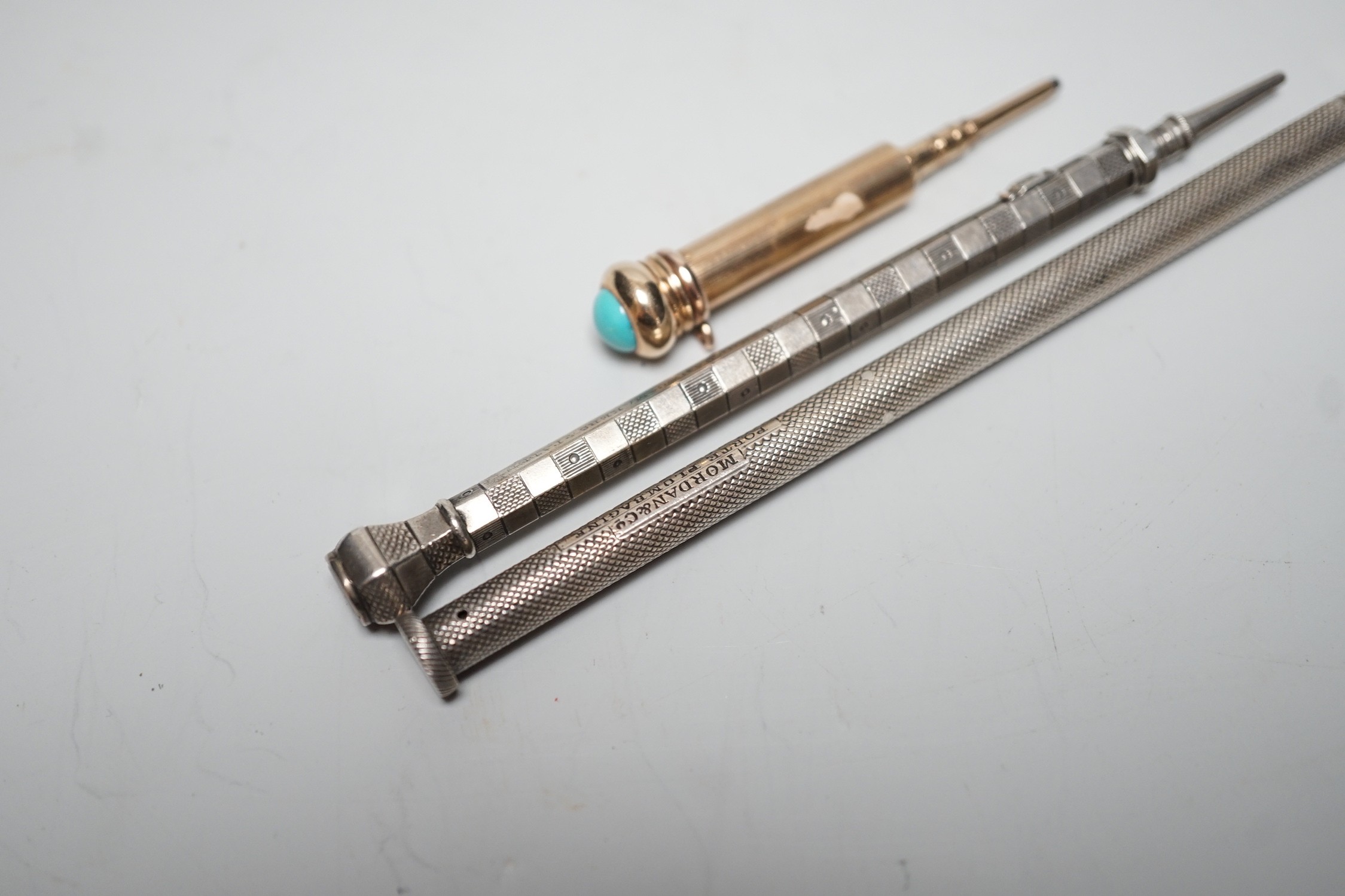 Two silver pencils and a turquoise set propelling pencil
